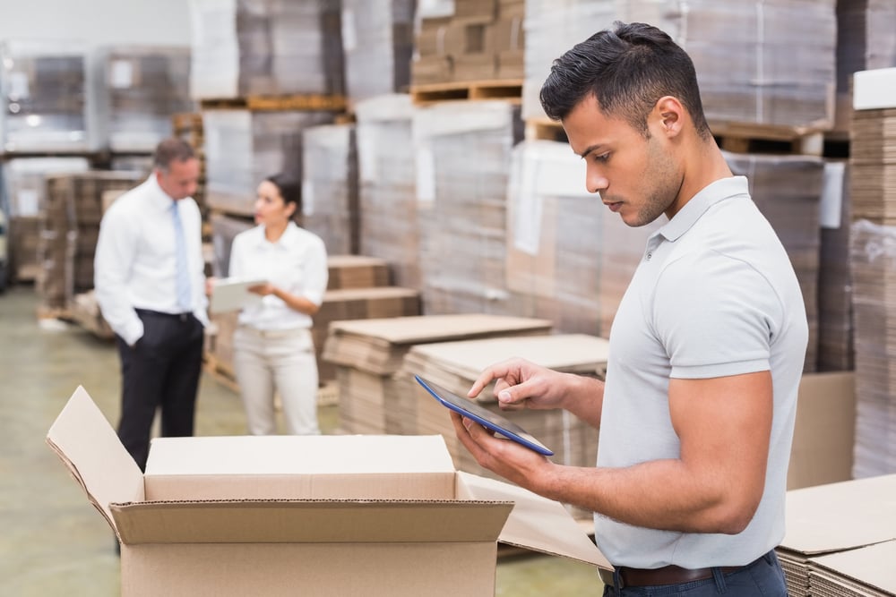 Portrait of male manager using digital tablet in warehouse Portrait of male manager using digital tablet in warehouse